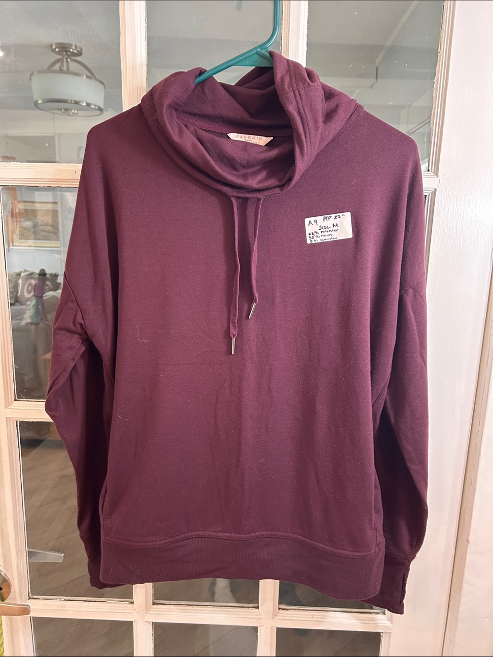 A9.    Danskin Plum Drawstring Turtleneck Sweater